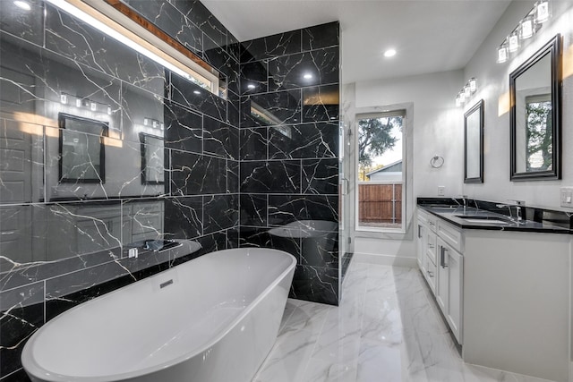 bathroom with plenty of natural light, a bathing tub, and vanity