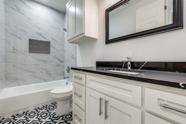 full bathroom with tiled shower / bath, vanity, and toilet