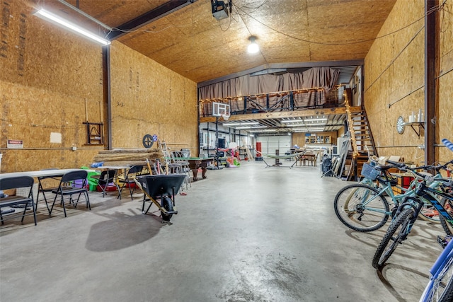 garage with a garage door opener and a workshop area