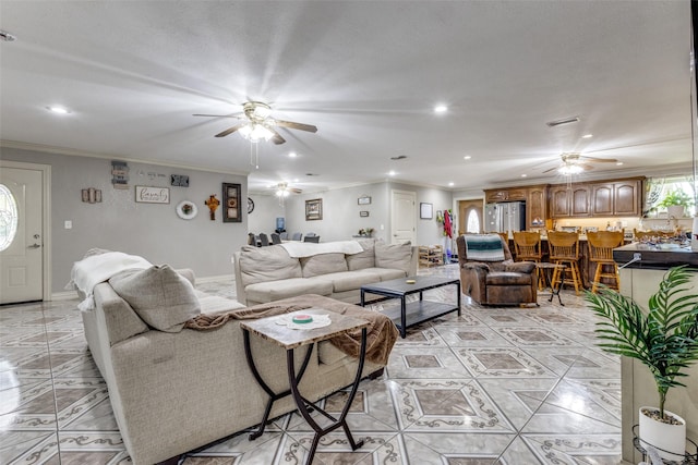 living room with crown molding, light tile patterned floors, and ceiling fan