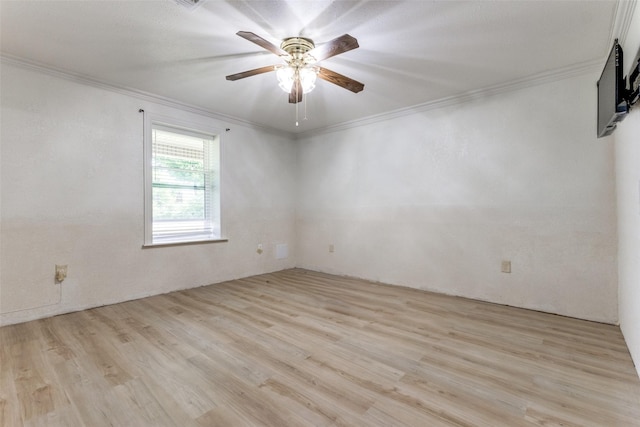 spare room featuring ornamental molding, ceiling fan, and light wood-type flooring