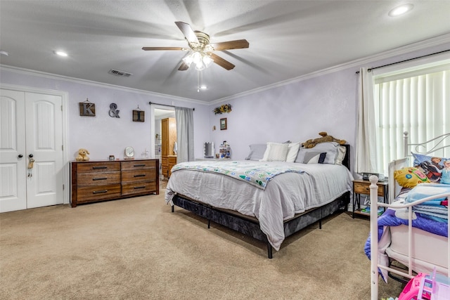 bedroom with crown molding, light carpet, ceiling fan, and a closet