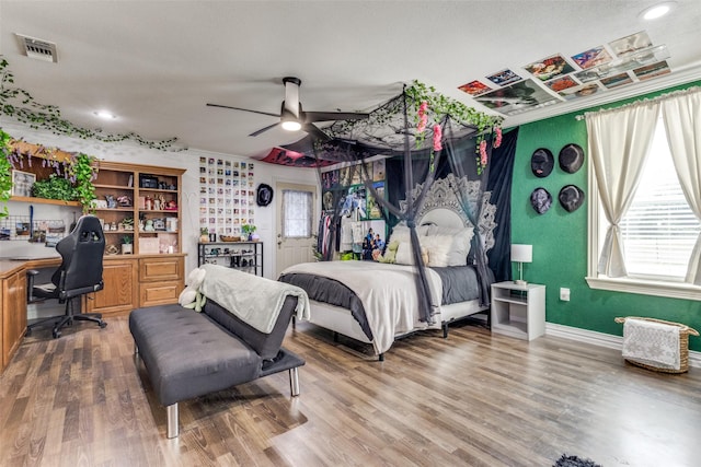 bedroom featuring hardwood / wood-style flooring and ornamental molding