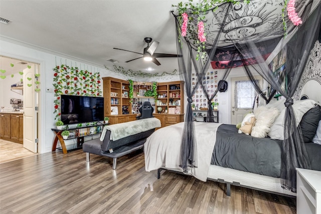 bedroom featuring hardwood / wood-style flooring and crown molding