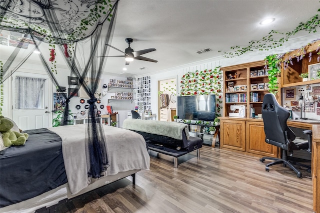 bedroom with wood-type flooring and ornamental molding