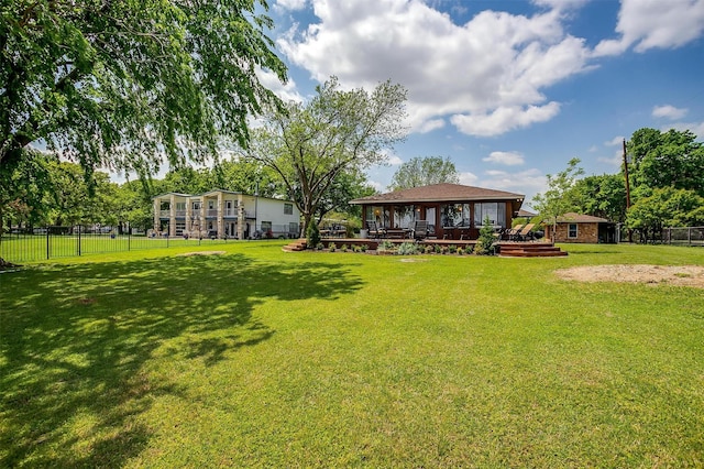 view of yard featuring fence, a wooden deck, and a gazebo
