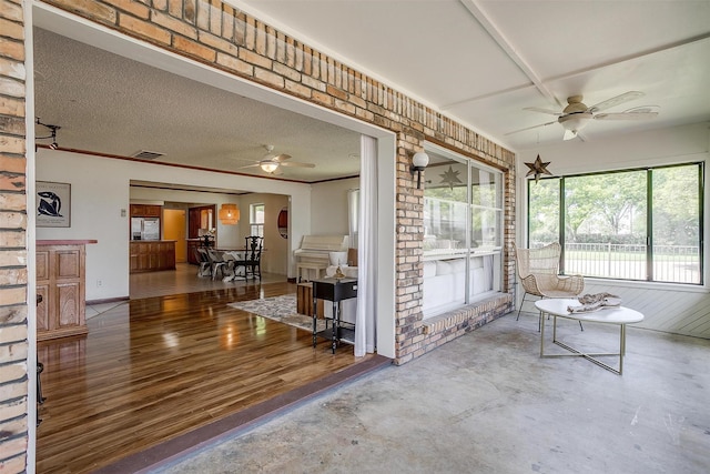 sunroom / solarium with a ceiling fan and visible vents