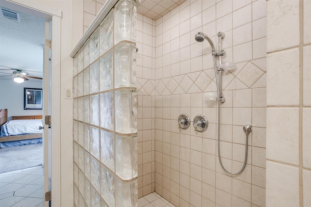 bathroom featuring a tile shower, visible vents, a ceiling fan, and ensuite bathroom