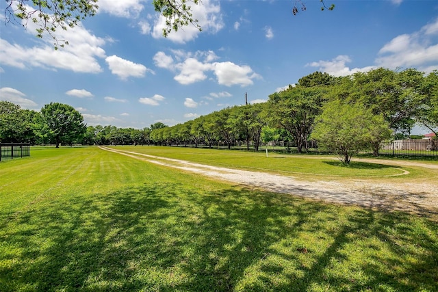 surrounding community with a yard and fence