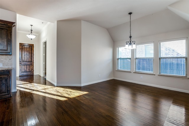 interior space with lofted ceiling, dark hardwood / wood-style flooring, and a notable chandelier