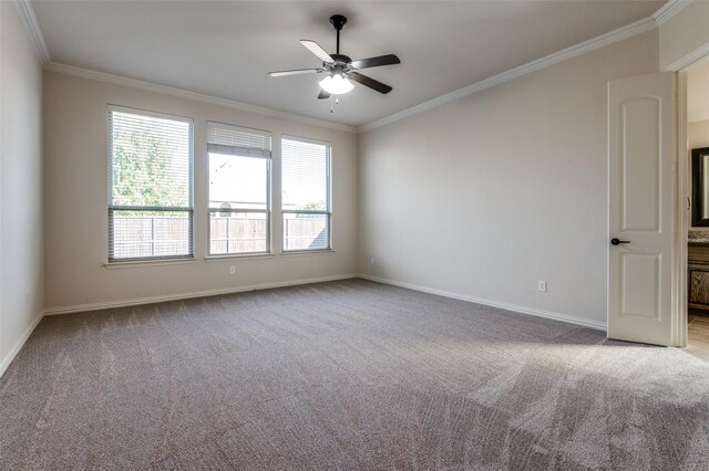 unfurnished bedroom featuring ensuite bath, ornamental molding, light colored carpet, and ceiling fan