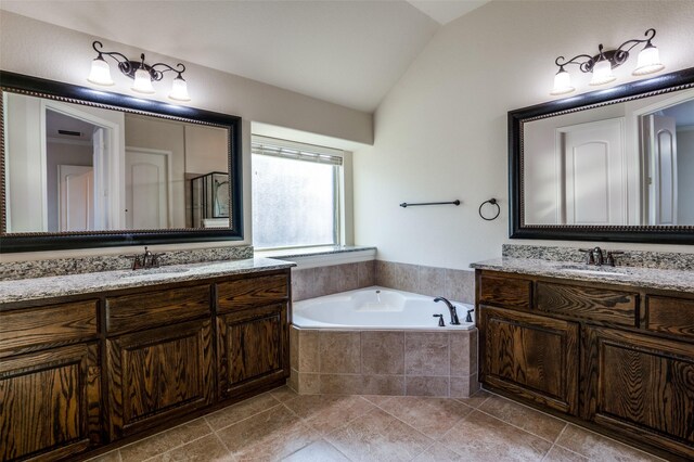 bathroom with vaulted ceiling, shower with separate bathtub, vanity, and tile patterned floors