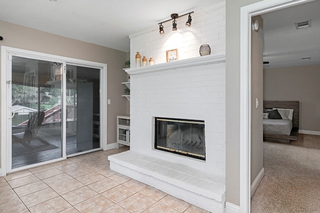 unfurnished living room featuring light tile patterned flooring and a fireplace