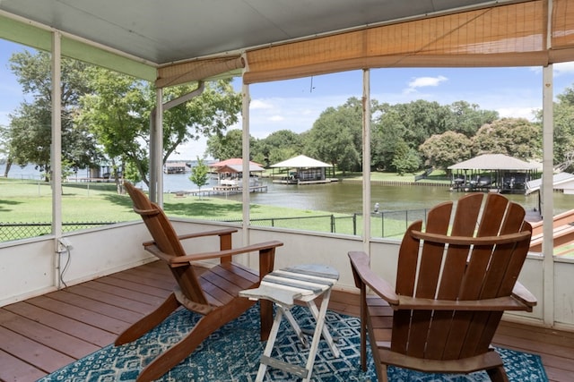 sunroom with plenty of natural light and a water view