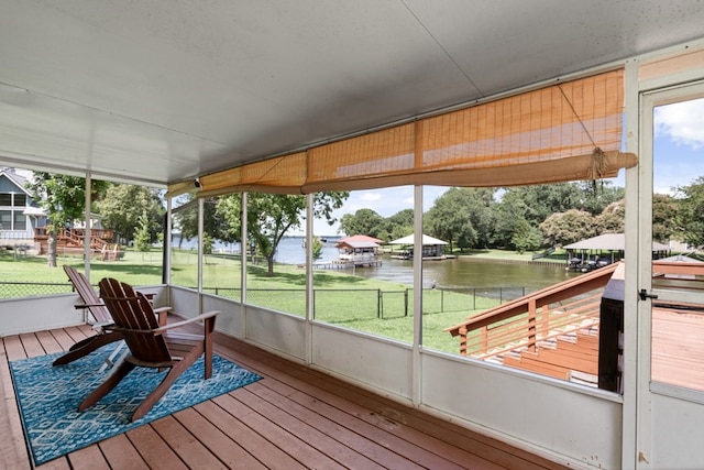 unfurnished sunroom featuring plenty of natural light and a water view