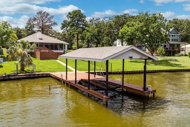 dock area featuring a water view and a lawn