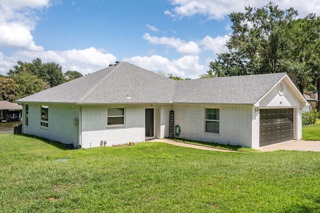 ranch-style house featuring a garage and a front yard