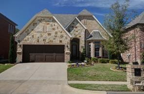 view of front of house with a garage and a front yard