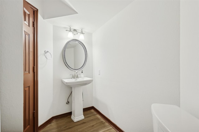 bathroom featuring hardwood / wood-style floors and toilet