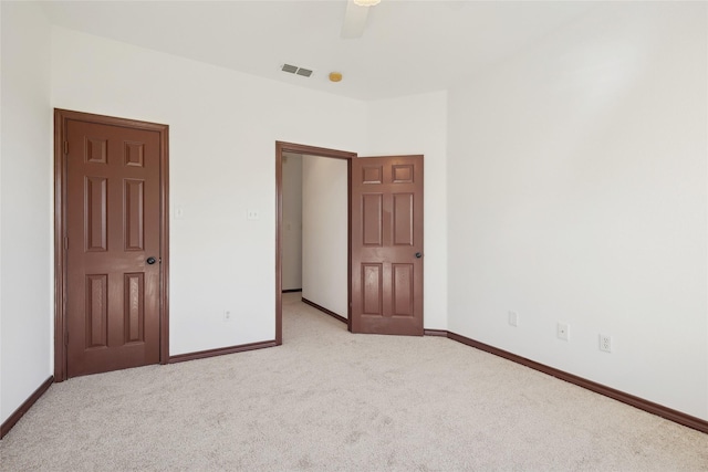 unfurnished bedroom with light carpet and ceiling fan