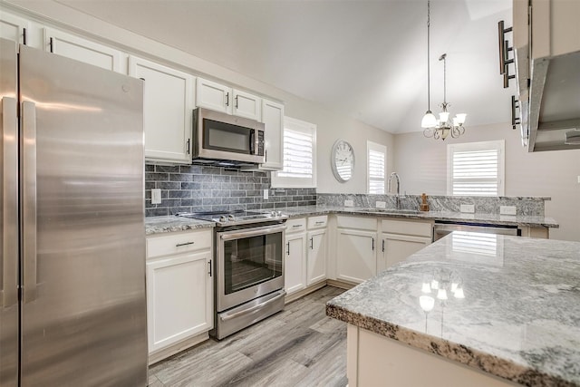 kitchen with pendant lighting, sink, white cabinetry, and stainless steel appliances