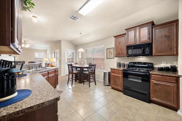 kitchen featuring vaulted ceiling, hanging light fixtures, light tile patterned floors, ceiling fan, and black appliances