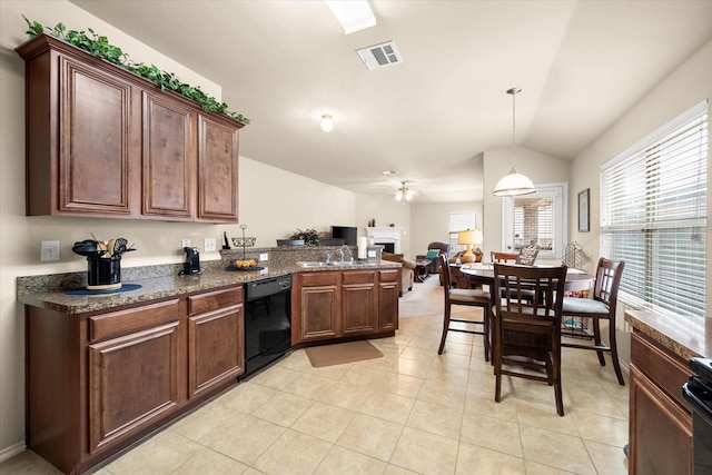 kitchen with vaulted ceiling, black dishwasher, hanging light fixtures, light tile patterned floors, and ceiling fan