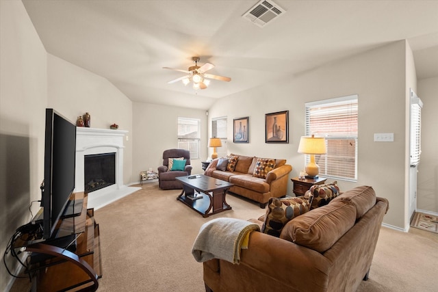 carpeted living room featuring lofted ceiling, a wealth of natural light, and ceiling fan