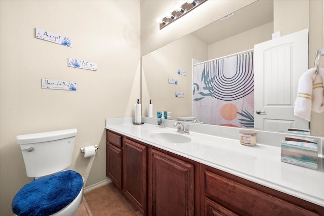 bathroom featuring tile patterned floors, vanity, and toilet