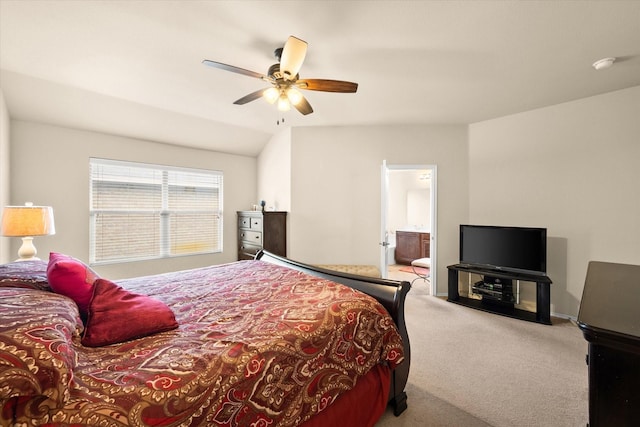 carpeted bedroom with ensuite bathroom, lofted ceiling, and ceiling fan