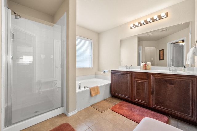 bathroom with vanity, independent shower and bath, and tile patterned flooring