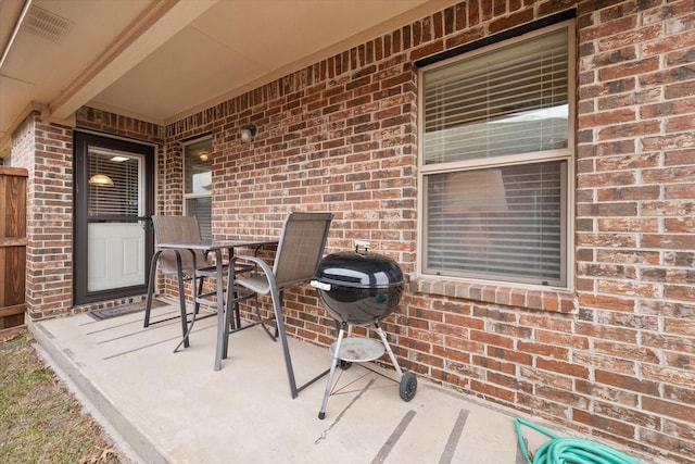 view of patio featuring a grill