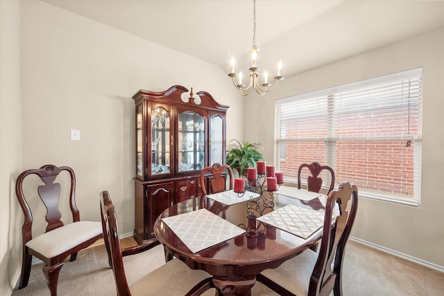 dining room with an inviting chandelier and light carpet