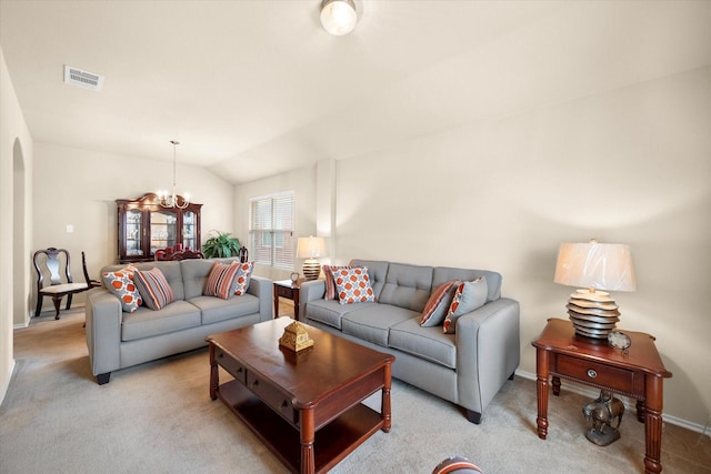 carpeted living room with lofted ceiling and an inviting chandelier