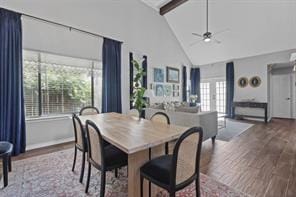 dining area featuring hardwood / wood-style floors, beam ceiling, high vaulted ceiling, and ceiling fan