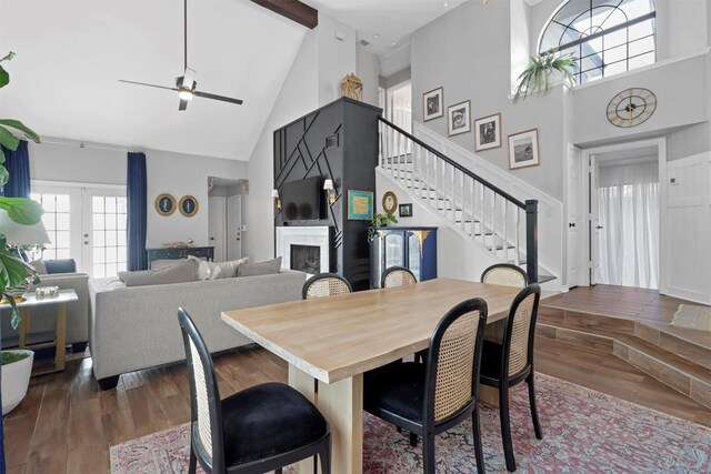 dining room featuring hardwood / wood-style flooring, beamed ceiling, high vaulted ceiling, and french doors