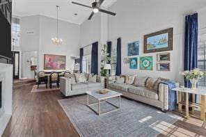 living room with a high ceiling, wood-type flooring, and a chandelier