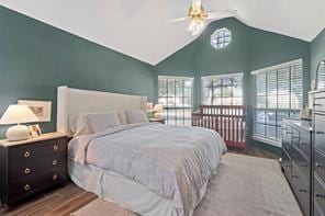 bedroom featuring hardwood / wood-style floors and vaulted ceiling