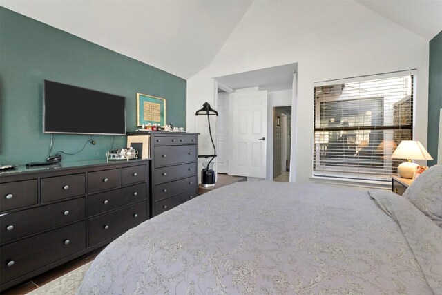 bedroom featuring lofted ceiling and hardwood / wood-style flooring