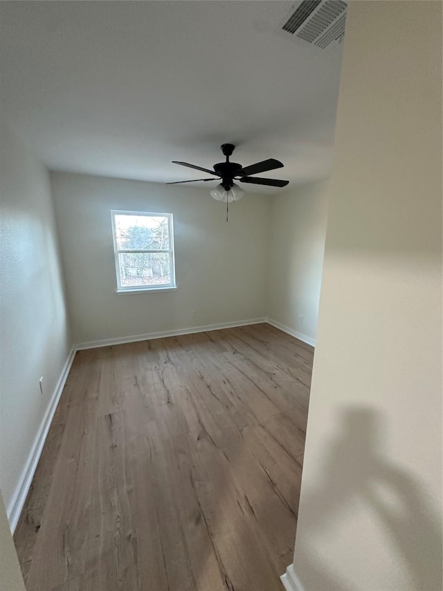 spare room featuring ceiling fan and light wood-type flooring