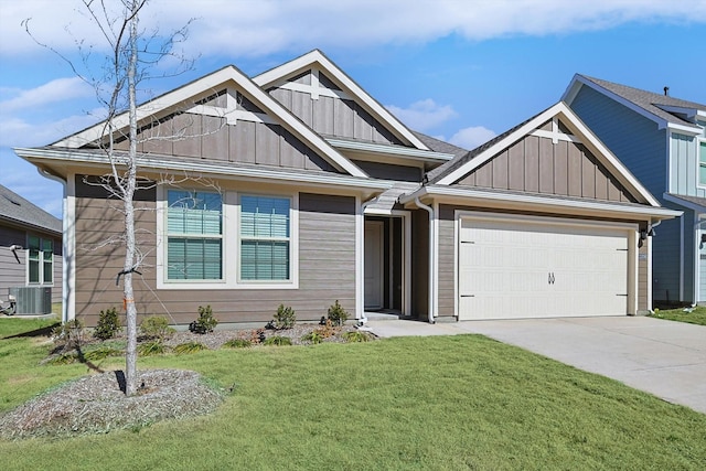 view of front of property with a garage, cooling unit, and a front lawn