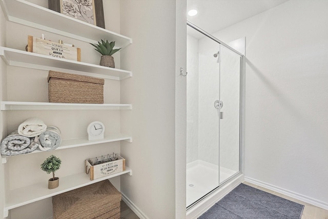 bathroom with a shower with door