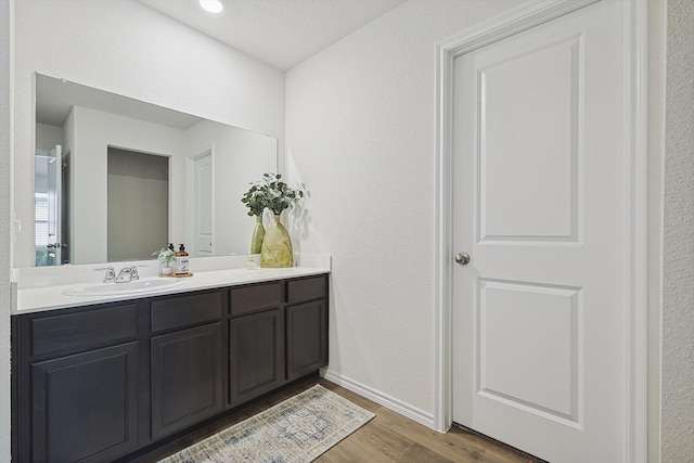 bathroom with hardwood / wood-style flooring and vanity