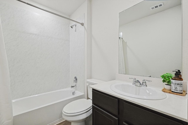 full bathroom featuring tiled shower / bath combo, vanity, and toilet