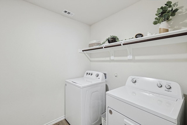 clothes washing area with separate washer and dryer