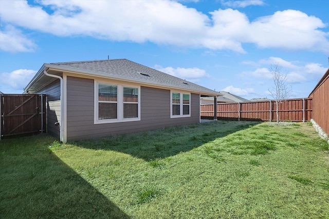 rear view of property featuring a yard