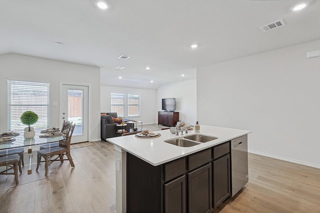 kitchen with sink, dishwasher, a kitchen island with sink, dark brown cabinets, and light hardwood / wood-style floors