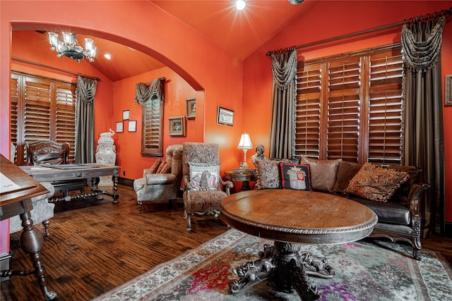 living area featuring hardwood / wood-style flooring, vaulted ceiling, and a notable chandelier