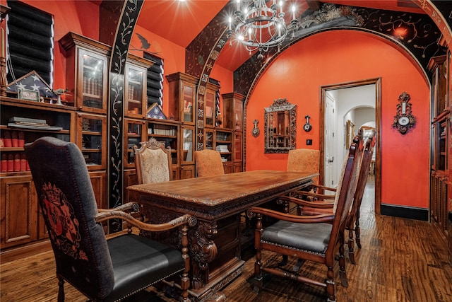 interior space featuring vaulted ceiling, a notable chandelier, and dark hardwood / wood-style flooring