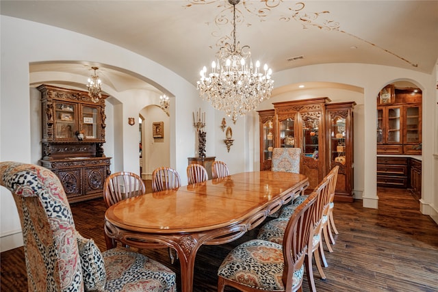 dining space featuring lofted ceiling and dark hardwood / wood-style floors